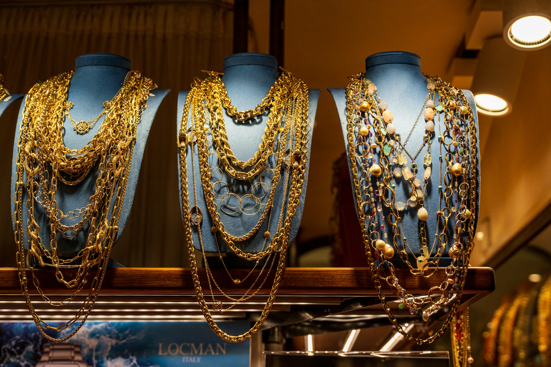 A bunch of necklaces that are on a shelf